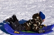 © Mehmet Dilsiz - Little Boy Sledding down the Hill