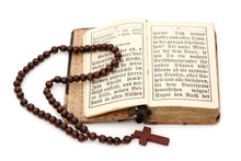 Old Bible And Rosary Isolated On White Background