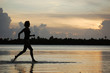 Young woman runner, jogging in water, Bora French Polynesia