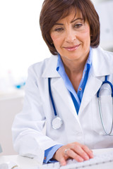 Wall Mural - Female doctor working at office