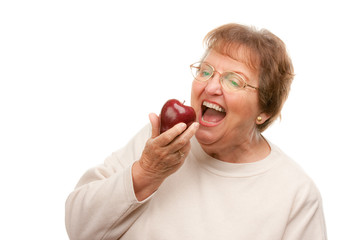 Wall Mural - Hungry Senior Woman Eats Apple.