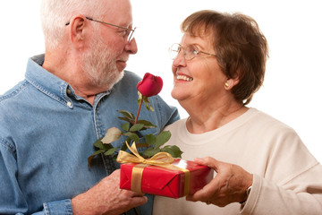 Wall Mural - happy senior couple with gift and red rose