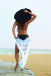 © Goodwyn - girl on a beach stands by a back