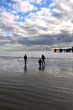 © Mehmet Dilsiz - Family Walking on the Beach