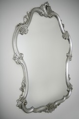 baroque silver mirror over white wall