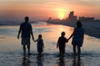 © sframe - Young Family Silhouetted By Sunset