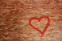 A Battered Brick Wall With A Sprayed Red Heart In Spotlight