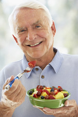 Senior Man Eating Fresh Fruit Salad