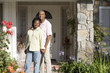 © Monkey Business - Couple Standing Outside Their House