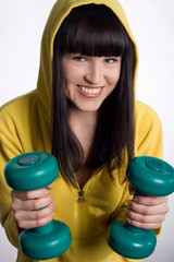 girl with two green dumbbells