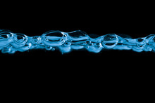 Blue Water Bubbles Isolated Over Black