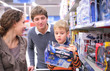 © Pavel Losevsky - Parents with son with toy in shop