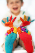 Happy Child With Painted Feet And Hands