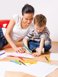 © ZoomTeam - mother and a 5-year old son painting on paper