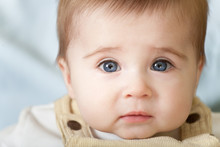 Portrait Of Pensive Blue-eyes Baby