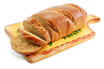 Whole wheat bread on the table wooden board isolated