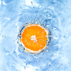 Wall Mural - fresh orange dropped into water with bubbles isolated on white