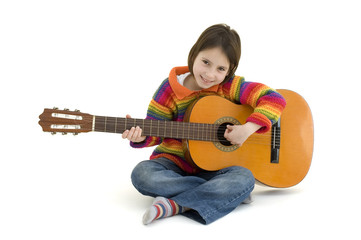 young girl playing acoustic guitar