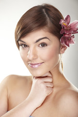 happy young woman with orchid