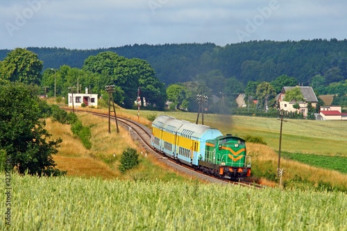 Naklejka na szafę Passenger train passing the countryside.