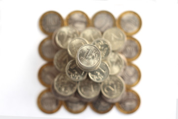 pyramid of coins isolated on white background from above