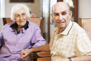 Wall Mural - Senior couple relaxing in armchairs