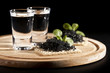 served place setting: vodka and sandwiches with black caviar on