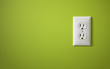 white electric outlet mounted on green wall