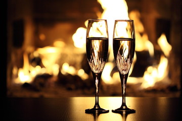 two glasses in front of fireplace