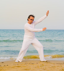 Poster - Man in white on a beach