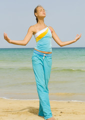 Wall Mural - Woman exercising on a beach