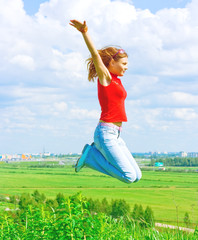 Wall Mural - Girl jumping over the land