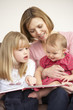 © Monkey Business - Mother And Daughters Reading Book