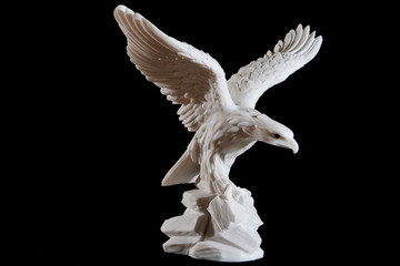 Poster - Classic white statuette of eagle isolated on black background