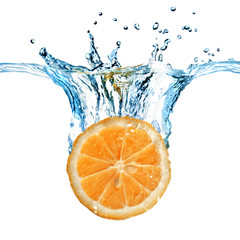 Wall Mural - fresh lemon dropped into water with splash isolated on white