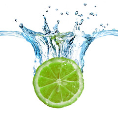 Wall Mural - fresh lemon dropped into water with splash isolated on white