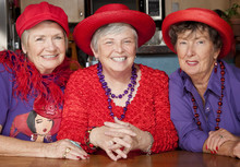 Three Senior Women Wearing Red Hats