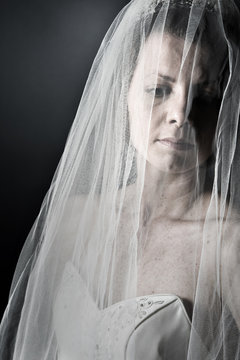 Bride in her Veil against Dark Background