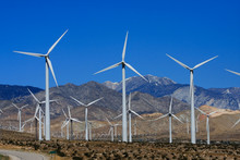 Wind Generators Snow Capped Mountains Blue Sky