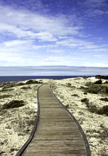 Boardwalk Over Sand Dunes With Blue Sky And Clouds On The Califo