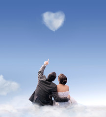 Wall Mural - heart of cloud - studio shot of a wedding couple
