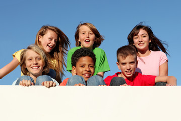 diverse group of kids holding banner at summer camp