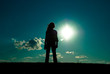 silhouette of a girl standing on a horizon