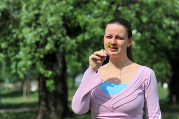 Young attractive female smelling a flower