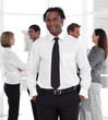 © WavebreakMediaMicro - Potrait of a Businessman standing in front of team