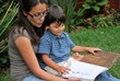 © JenKedCo - Young Hispanic mother reads to her son