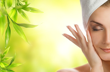 Beautiful young woman applying organic cosmetics to her skin