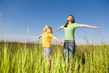 Wall Mural - Happy mother and daughter at field