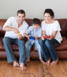 © WavebreakMediaMicro - Happy family playing video games
