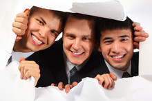 Three Young Smiling Men Looking Out In Hole In Paper